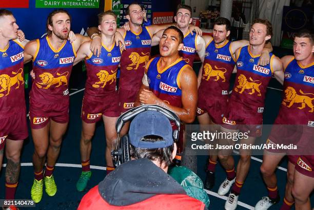 Cedric Cox of the lions sings the team song after victory during the round 18 AFL match between the Brisbane Lions and the Carlton Blues at The Gabba...