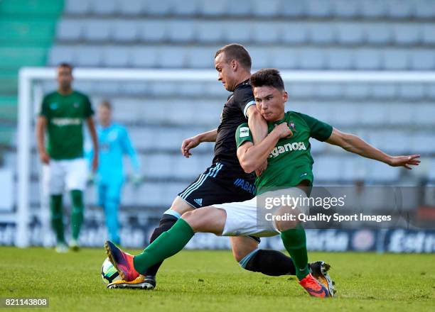 Aitor Pascual of Racing de Ferrol competes for the ball with Stanislav Lobotka of Celta de Vigo during the pre-season friendly match between Celta de...