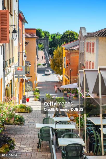 beautiful street of french trevoux town in auvergne-rhone-alpes region  with some tourists in sunny summer day - auvergne rhône alpes stock pictures, royalty-free photos & images