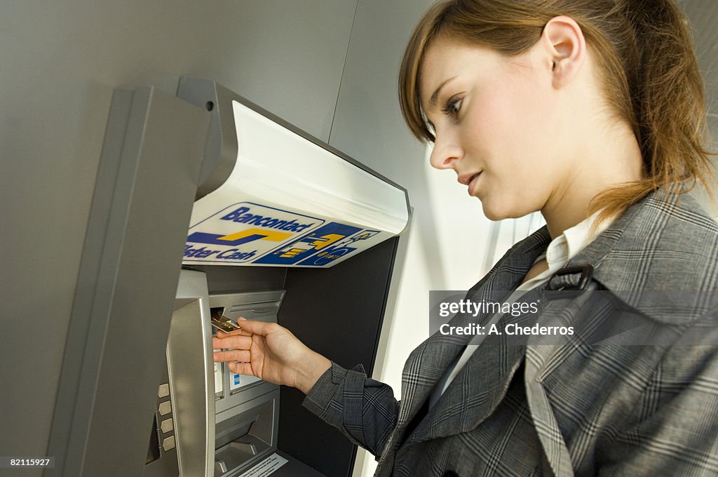 Side profile of a businesswoman using an ATM