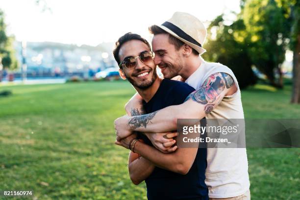 young man kissing his boyfriend for farewell - 20 29 years stock pictures, royalty-free photos & images