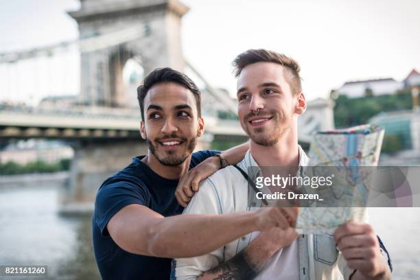 gay couple visiting landmarks before farewell in eastern europe - budapest map stock pictures, royalty-free photos & images