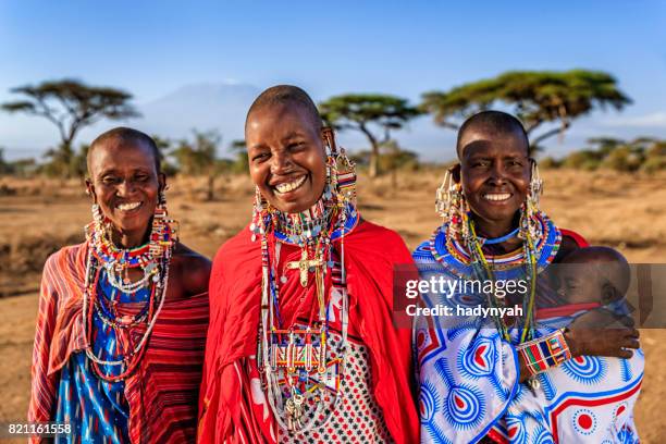 afrikanische frau, die ihr baby, kenia, osten und afrika - african village stock-fotos und bilder