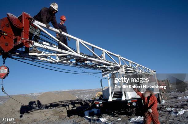 Workers set up a mobile rig to drill for methane gas March 16, 2001 near Gillette in eastern Wyoming, a region that sits atop one of the world's...