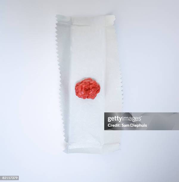 chewed gum on gum wrapper - candy wrapper stock-fotos und bilder