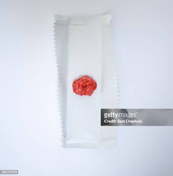 chewed gum on gum wrapper - candy wrapper stockfoto's en -beelden