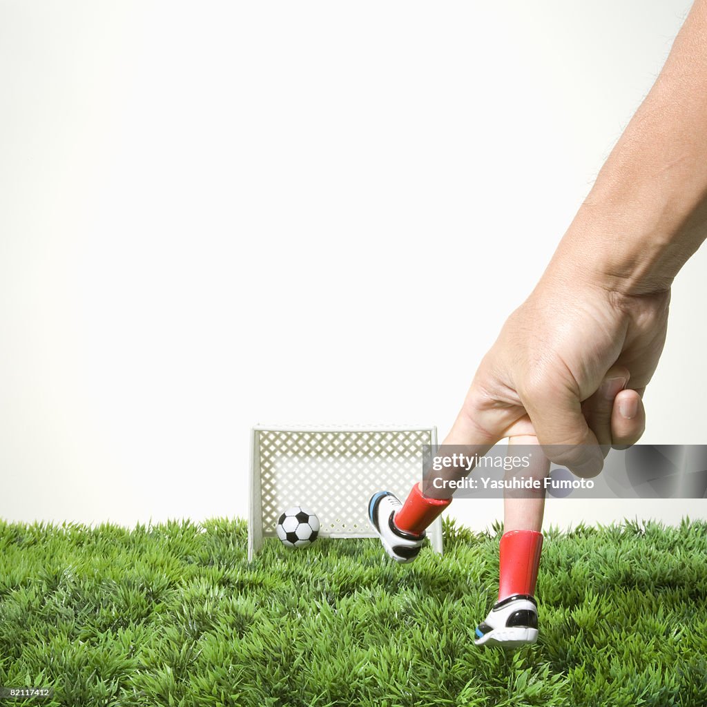 Kicking A Soccer Ball With Finger Imitating Foot High-Res Stock Photo ...