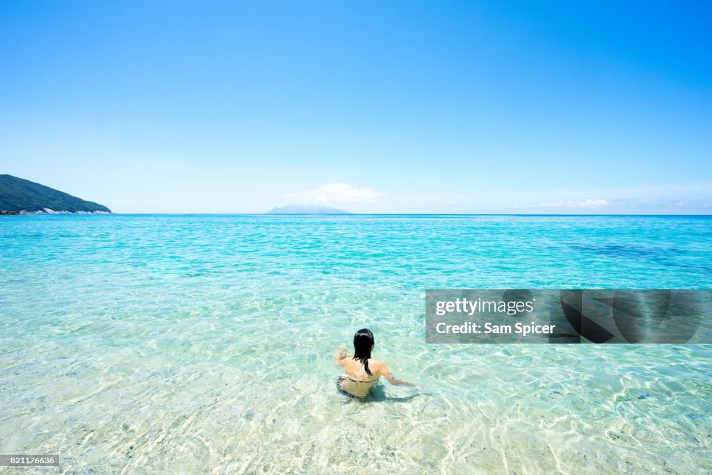 Tourist enjoying tropical beach paradise in Yakushima Island, Japan