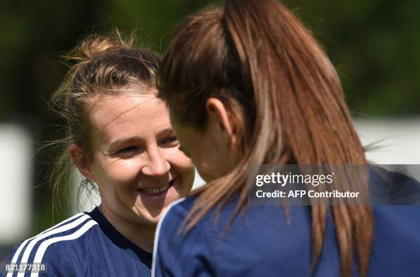 Scotland's player Frankie Brown smiles next to a teammate during a training session in Woudenberg on July 21 during the UEFA Women's Euro 2017...