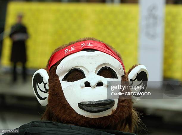 Woman wears a mask on the back of her head during an Amnesty International event in Sydney on July 30, 2008 as part of a campaign to end internet...