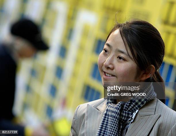 Woman listens to speeches during an Amnesty International event in Sydney on July 30, 2008 as part of a campaign to end internet censorship in China....