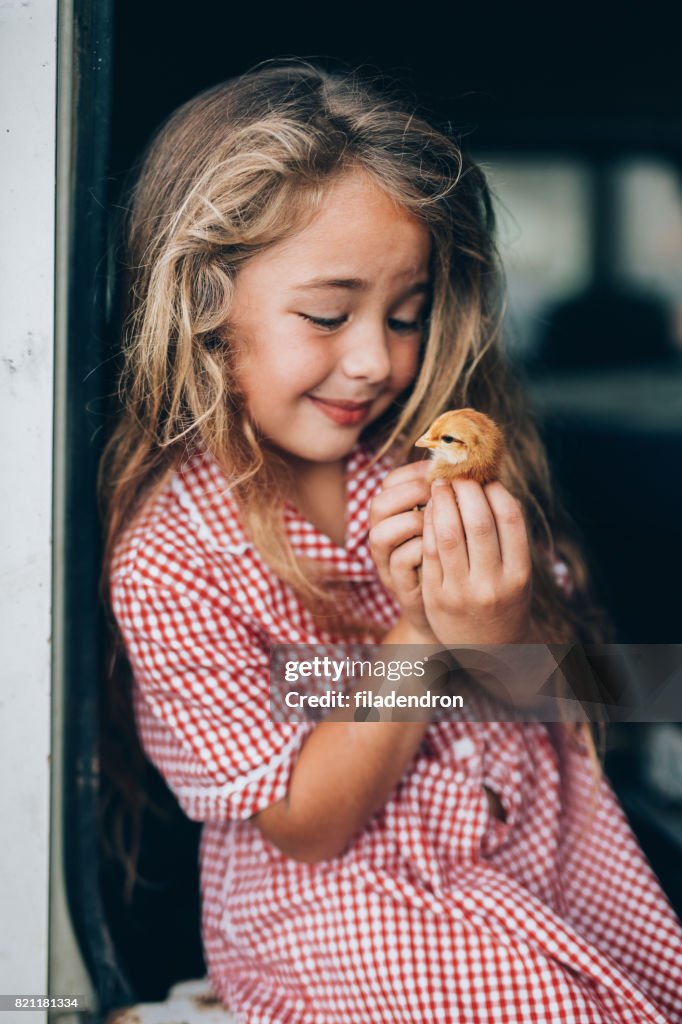 Girl with a little chicken