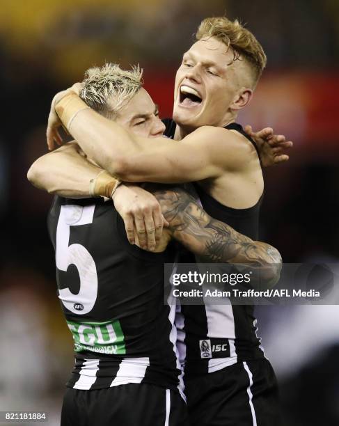 Jamie Elliott of the Magpies celebrates a late goal to put Collingwood in front with Adam Treloar of the Magpies during the 2017 AFL round 18 match...