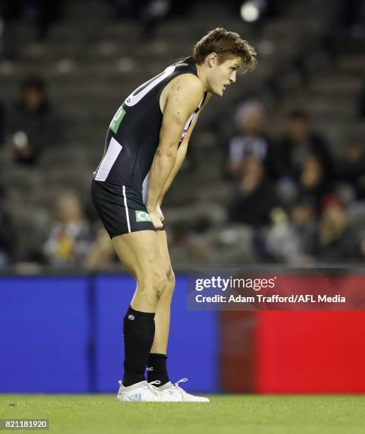 Darcy Moore of the Magpies gets up slowly after a big hit during the 2017 AFL round 18 match between the Collingwood Magpies and the West Coast...