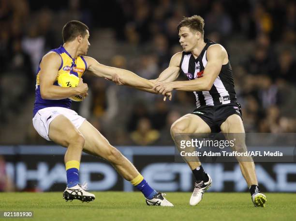 Liam Duggan of the Eagles is tackled by Josh Thomas of the Magpies during the 2017 AFL round 18 match between the Collingwood Magpies and the West...