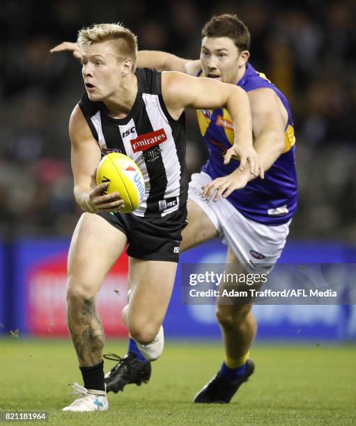 Jordan De Goey of the Magpies in action ahead of Jeremy McGovern of the Eagles during the 2017 AFL round 18 match between the Collingwood Magpies and...