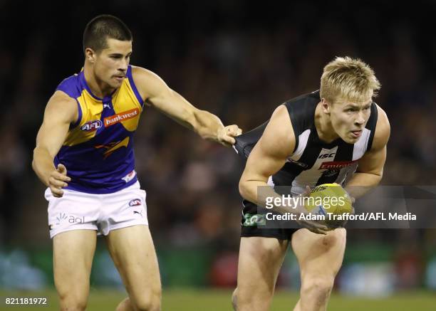 Jordan De Goey of the Magpies is tackled by Liam Duggan of the Eagles during the 2017 AFL round 18 match between the Collingwood Magpies and the West...