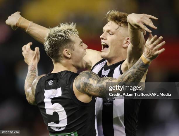 Jamie Elliott of the Magpies celebrates a late goal to put Collingwood in front with Adam Treloar of the Magpies during the 2017 AFL round 18 match...