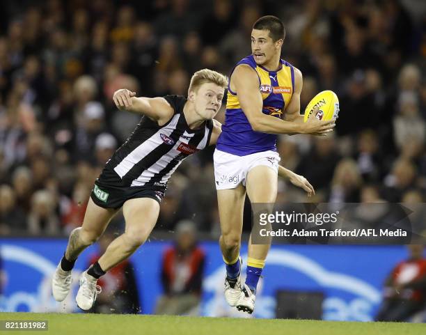 Liam Duggan of the Eagles is tackled by Jordan De Goey of the Magpies during the 2017 AFL round 18 match between the Collingwood Magpies and the West...