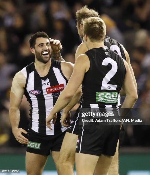 Alex Fasolo of the Magpies celebrates a late goal to seal the match with teammates during the 2017 AFL round 18 match between the Collingwood Magpies...