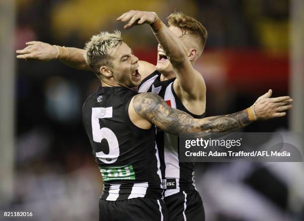 Jamie Elliott of the Magpies celebrates a late goal to put Collingwood in front with Adam Treloar of the Magpies during the 2017 AFL round 18 match...