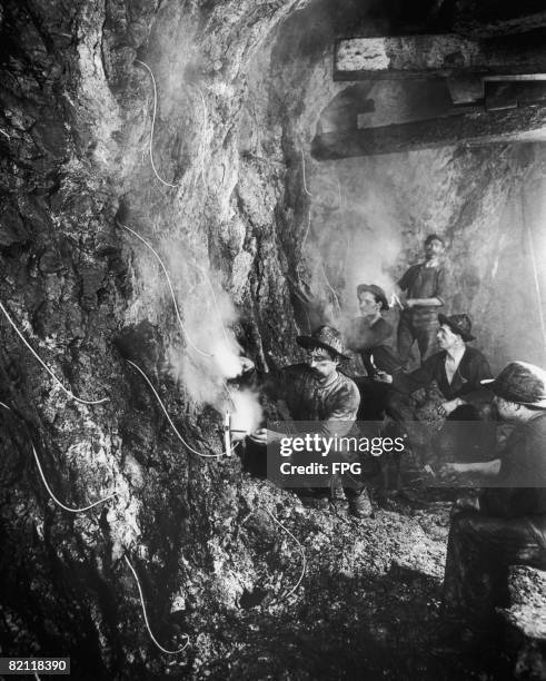 Workers laying explosives in an iron mine, 1880.