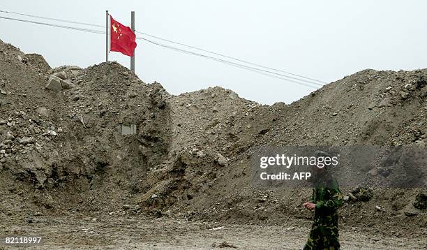 In this photograph taken on July 10, 2008 a Chinese soldier stands guard on the Chinese side of the ancient Nathu La border crossing between India...