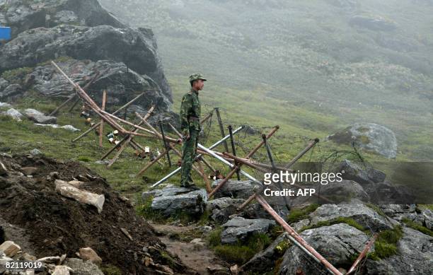 In this photograph taken on July 10 a Chinese soldier stands guard on the Chinese side of the ancient Nathu La border crossing between India and...