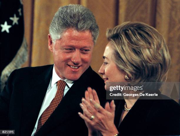 President Clinton speaks with Hillary during an event about Social Security and Medicare in the East Room of the White House February 17, 1999....