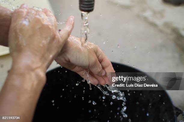 woman washing her hands - hands fountain water stock-fotos und bilder