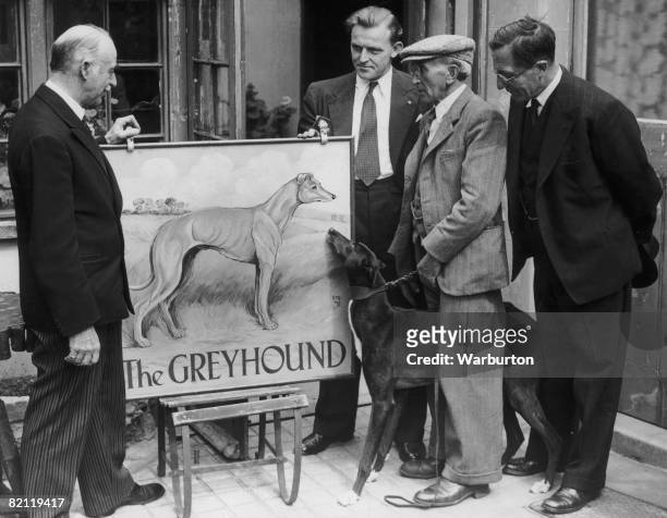 New sign about to be hung outside 'The Greyhound', an old coaching inn in Carshalton, Surrey, 20th August 1948. From left to right, Sir G....