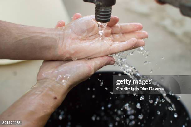 woman washing her hands - groundwater stock pictures, royalty-free photos & images