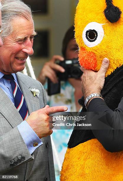 Prince Charles, Prince of Wales laughs at a man dressed as a Bee as he tours the Sandringham Flower Show on July 30, 2008 in Sandringham, England.