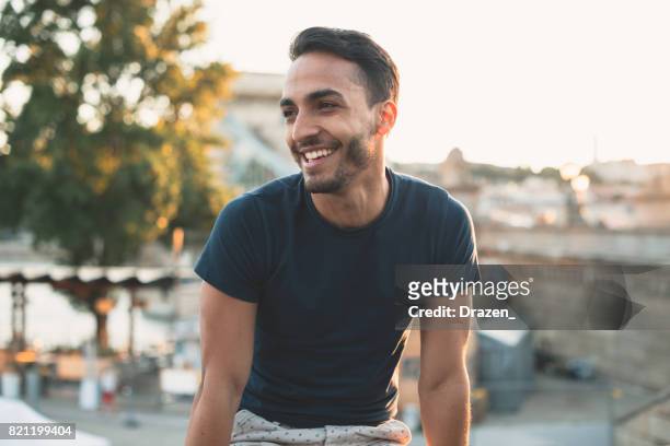 cheerful latin man traveling around europe - 20 29 years stock pictures, royalty-free photos & images