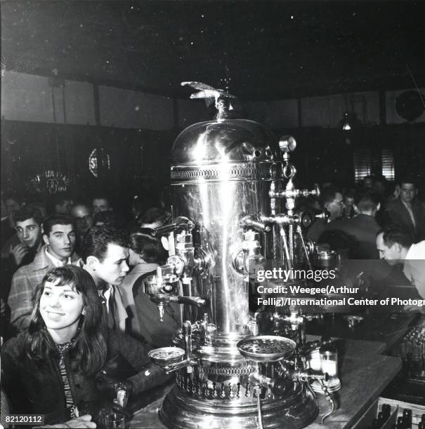 View of the crowded San Remo bar, Greenwich Village, New York, New York, mid 1950s. A massive espresso machine sits on the counter in center.