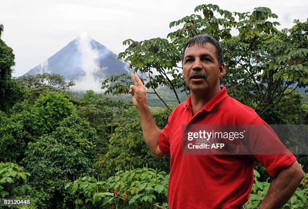 Costa Rican vulcanologist and member of the Costa Rican National University Eliecer Duarte, speaks as he points at the Arenal vulcano on July 29,...