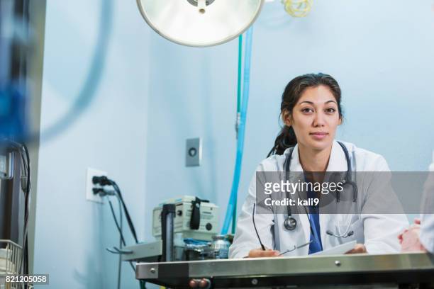 young medical professional wearing white lab coat - doctor headshot stock pictures, royalty-free photos & images