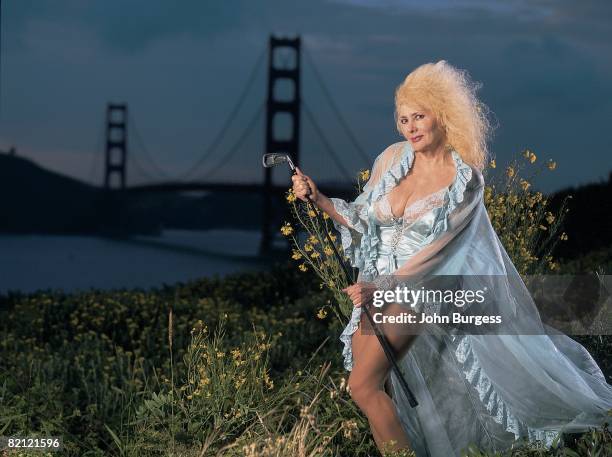 Golf: Scenic casual portrait of former Condor Club dancer Carol Doda with club, equipment at Golden Gate Bridge, San Francisco, CA 5/31/1998