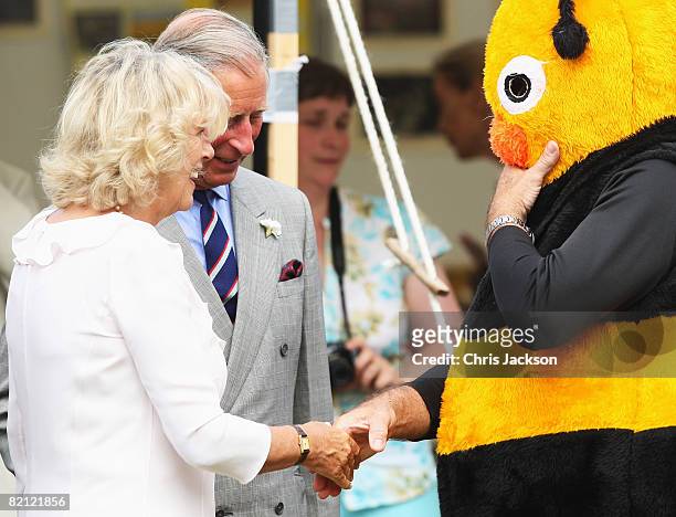 Camilla, Duchess of Cornwall laughs at a man dressed as a Bee as she tours the Sandringham Flower Show on July 30, 2008 in Sandringham, England.