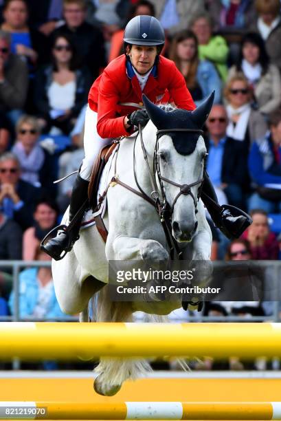 Rider Laura Kraut with her horse Zeremonie jumps over an obstacle during the Grand Prix of Aachen during the World Equestrian Festival CHIO in Aachen...