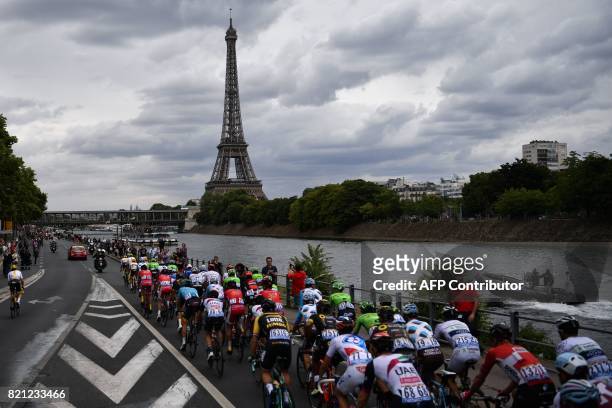 The pack rides in front of the Eiffel Tower and the Seine river during the 103 km twenty-first and last stage of the 104th edition of the Tour de...