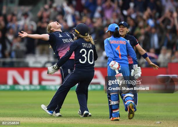 Anya Shrubsole of England celebrates with team-mates Sarah Taylor and Heather Knight after taking the final India wicket of Rajeshwari Gayakwad to...