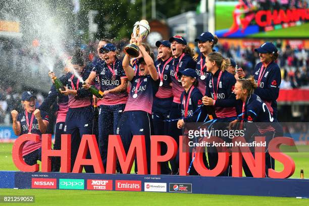 The England team pose for a photo after victory in the ICC Women's World Cup 2017 Final between England and India at Lord's Cricket Ground on July...