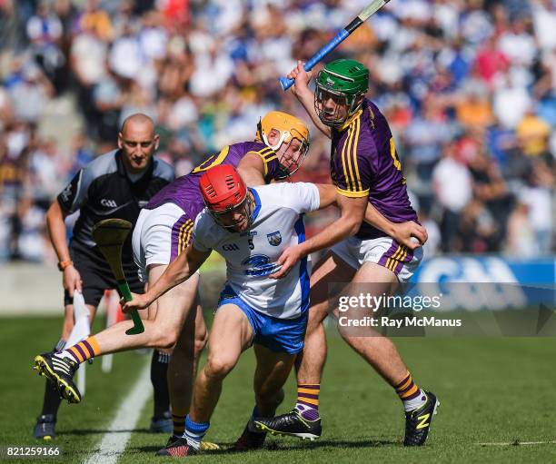 Cork , Ireland - 23 July 2017; Tadhg de Búrca of Waterford is tackled by Podge Doran, left, and Simon Donohoe of Wexford during the GAA Hurling...