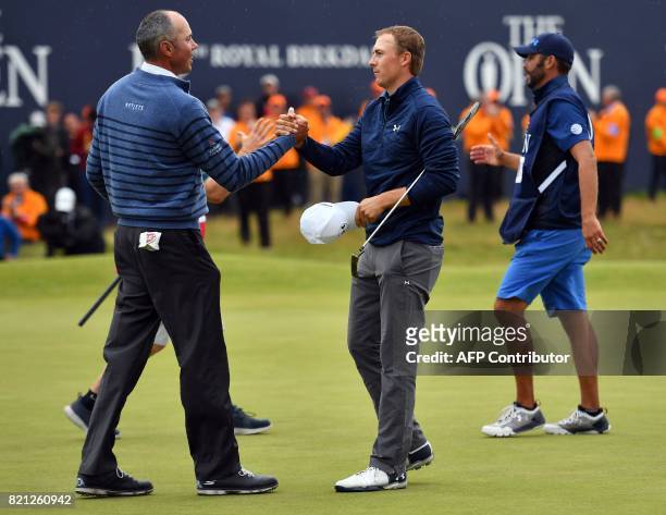 Golfer Jordan Spieth shakes hands with US golfer Matt Kuchar on the 18th green after their final rounds on day four of the 2017 Open Golf...