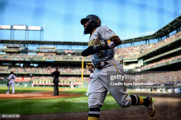 Pittsburgh Pirates second baseman Josh Harrison returns to the dugout after scoring in the first inning during a regular season Major League Baseball...