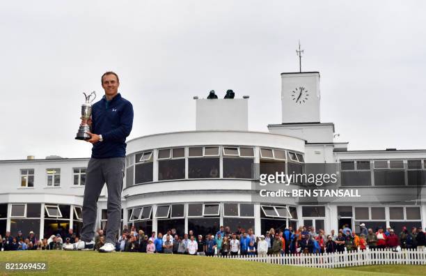 Golfer Jordan Spieth poses for pictures with the Claret Jug, the trophy for the Champion golfer of the year, in front of the Art-Deco-style...