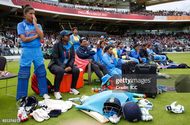 Indian players and managment look on as the team collapses during The ICC Women's World Cup 2017 Final between England and India at Lord's Cricket...