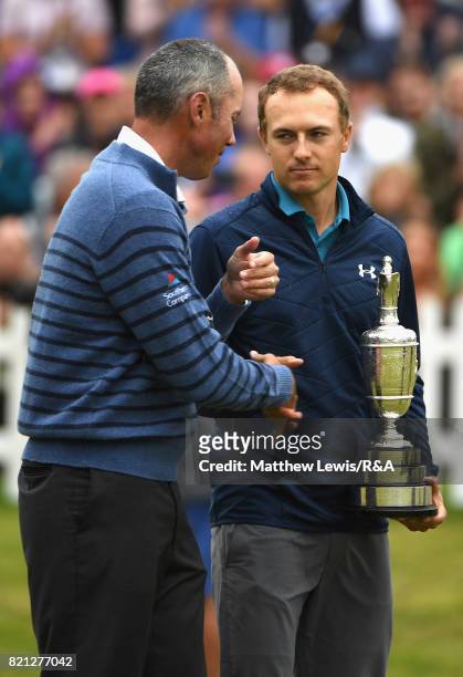Jordan Spieth of the United States holds the Claret Jug and is congratulated by Matt Kuchar of the United States after winning the 146th Open...