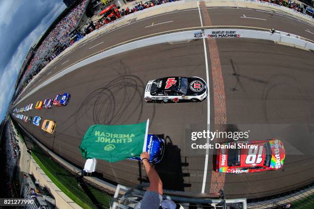 Kyle Busch, driver of the Skittles Toyota, leads the field past the green flag to start the Monster Energy NASCAR Cup Series Brickyard 400 at...